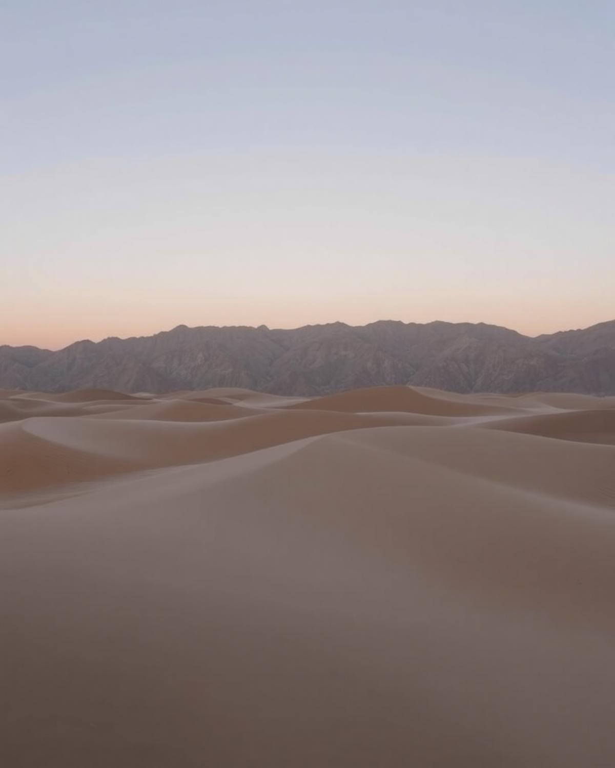 Katpana cold desert sand dunes near Skardu at dusk with the Karakoram behind