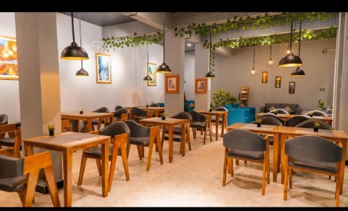 Dining room with timber tables and pendant lights at Arcadian Resort Skardu